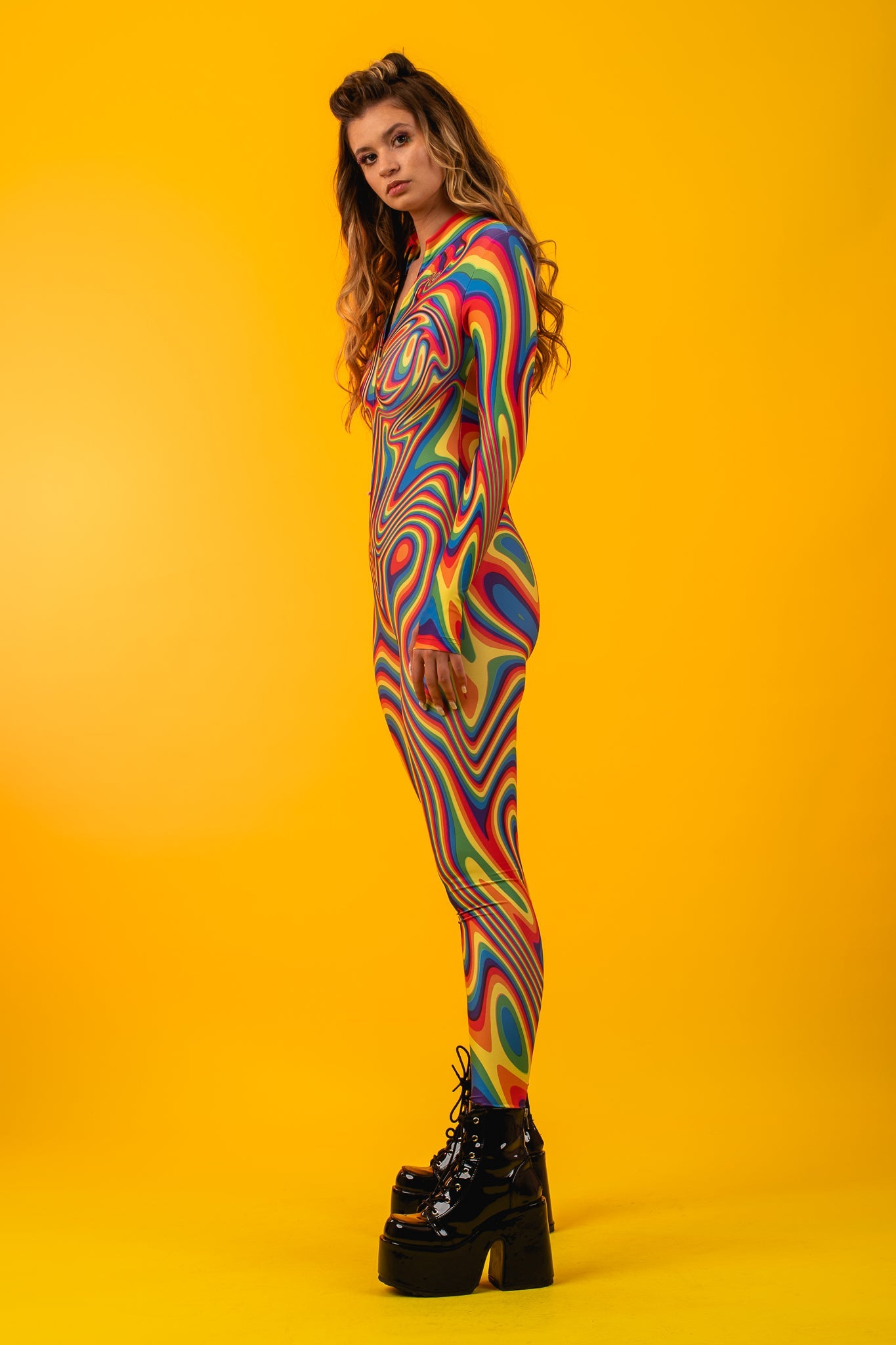 Woman wearing the Rainbow Liquid costume, a vibrant full-body suit with a colorful liquid effect, ideal for music festivals or creative events.