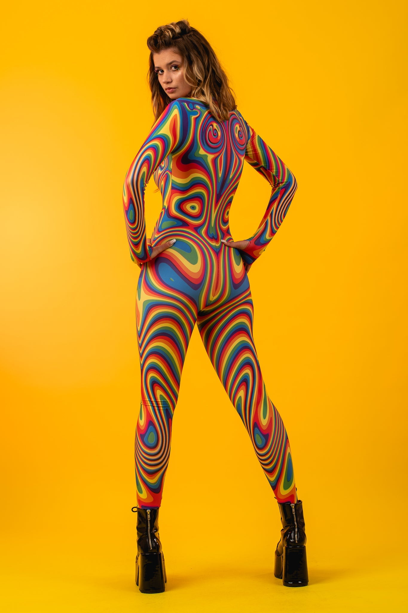 Woman posing in the Rainbow Liquid Festival costume, highlighting the bold rainbow liquid design, great for festivals or as a unique party outfit.