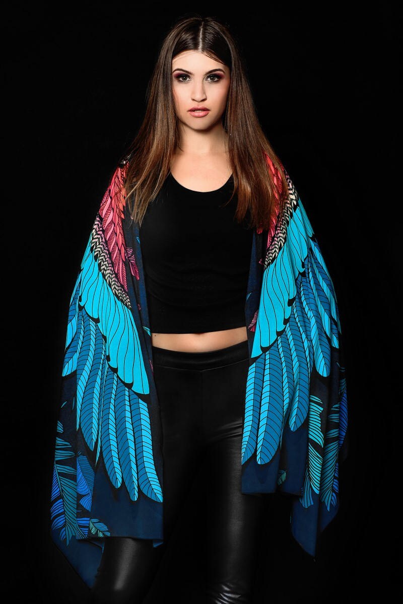 Model wearing the Skull Wings scarf, showcasing the intricate skull and feathered wing print, great for Halloween or as a unique gothic shawl.