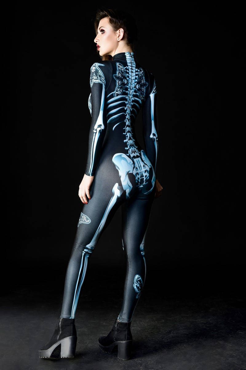 Woman wearing the Dark Skeleton Halloween costume, a gothic full-body catsuit with blue skeleton and skull moth accents, perfect for Halloween parties or gothic festivals.