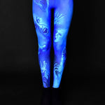 Woman wearing Ghost Scream leggings, featuring a haunting blue ghost design, perfect for Halloween events or as part of a gothic outfit.