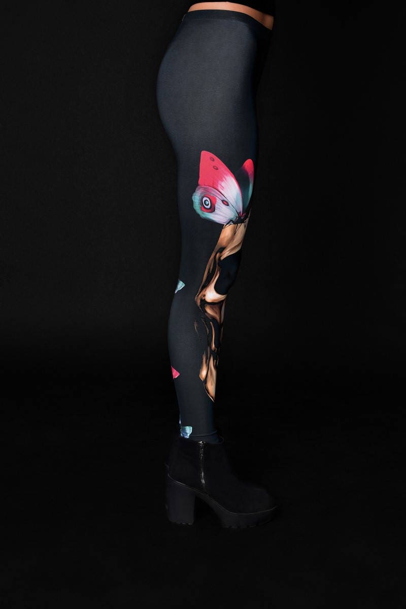 Woman wearing Skull Butterflies leggings, with detailed skull and butterfly prints, ideal for Halloween events or as part of a gothic outfit.