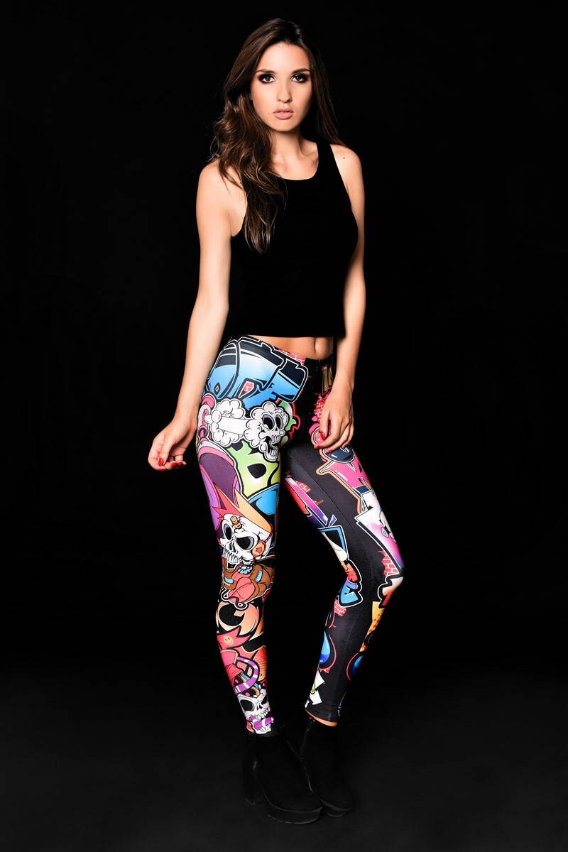 Woman wearing Skull Graffiti Style leggings, featuring colorful skull graffiti prints, perfect for Halloween parties, yoga, or as edgy casual wear.