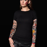 Woman posing in the Pumpkin Halloween T-shirt with tattoo pumpkin sleeves, showcasing the Halloween-themed design, great for Halloween parties or as a statement top.