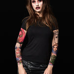 Woman posing in the Black Mirror Circus Halloween T-shirt, showcasing the detailed clown and circus tattoo prints, great for Halloween or as a standout statement shirt.