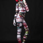 Woman posing in the Occult Mummy costume, highlighting the eerie skeleton and mummy wrap design, great for Halloween or as a standout horror festival outfit.