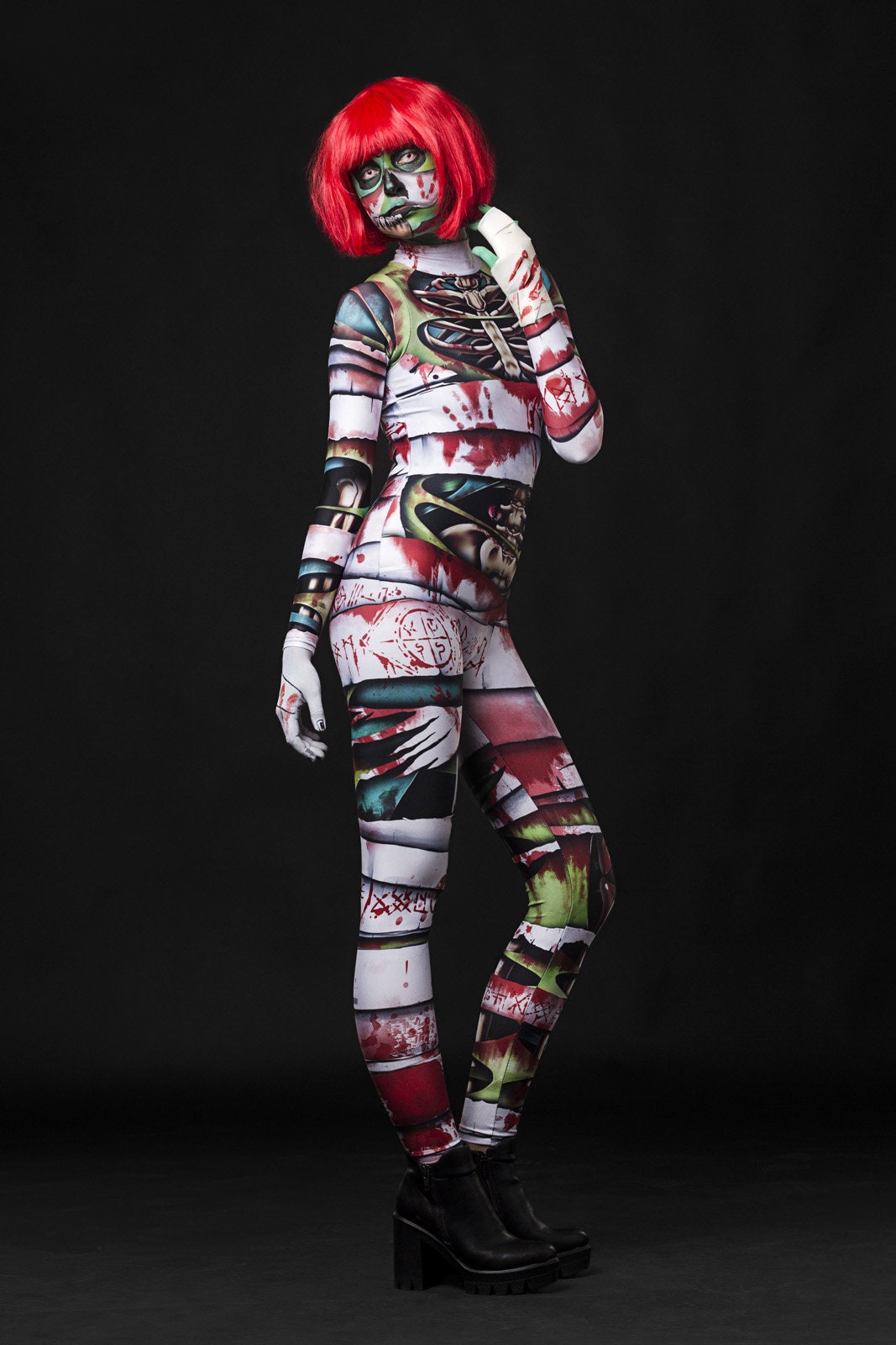 Woman posing in the Occult Mummy costume, highlighting the eerie skeleton and mummy wrap design, great for Halloween or as a standout horror festival outfit.