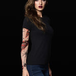 Woman wearing the Spiders Halloween T-shirt with tattoo-style spiderweb sleeves, ideal for Halloween events or casual gothic outfits.