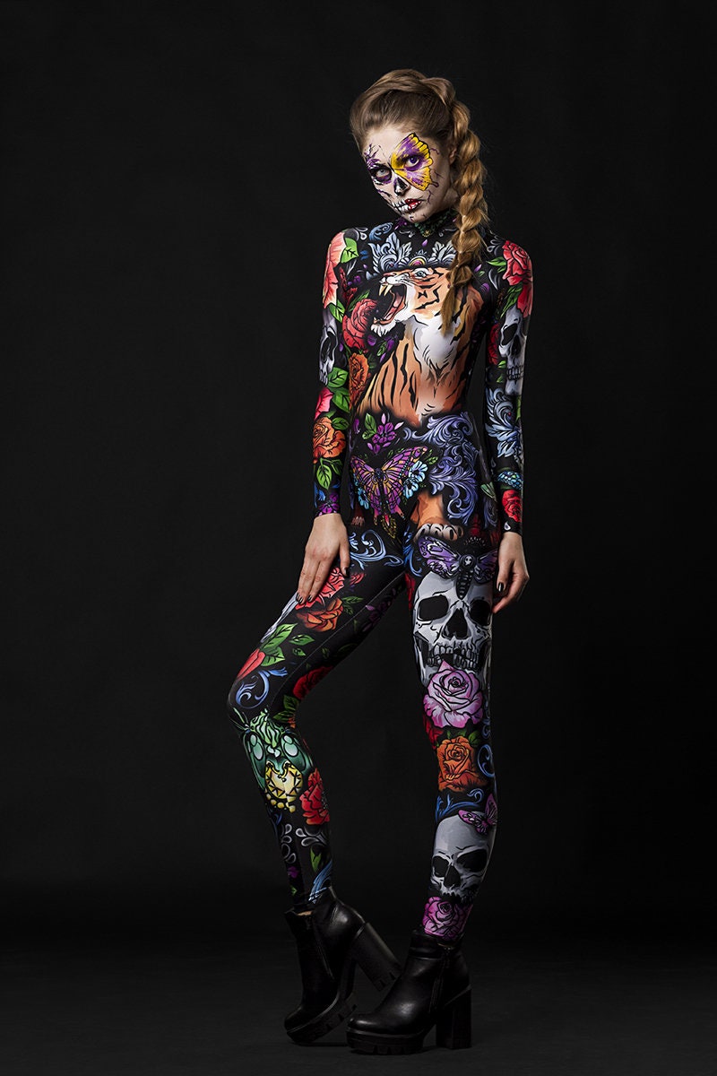 Woman posing in the Tattoo Style Halloween catsuit, showcasing the detailed tattoo-style tiger, skull, and butterfly designs, great for Halloween or as a standout festival outfit.