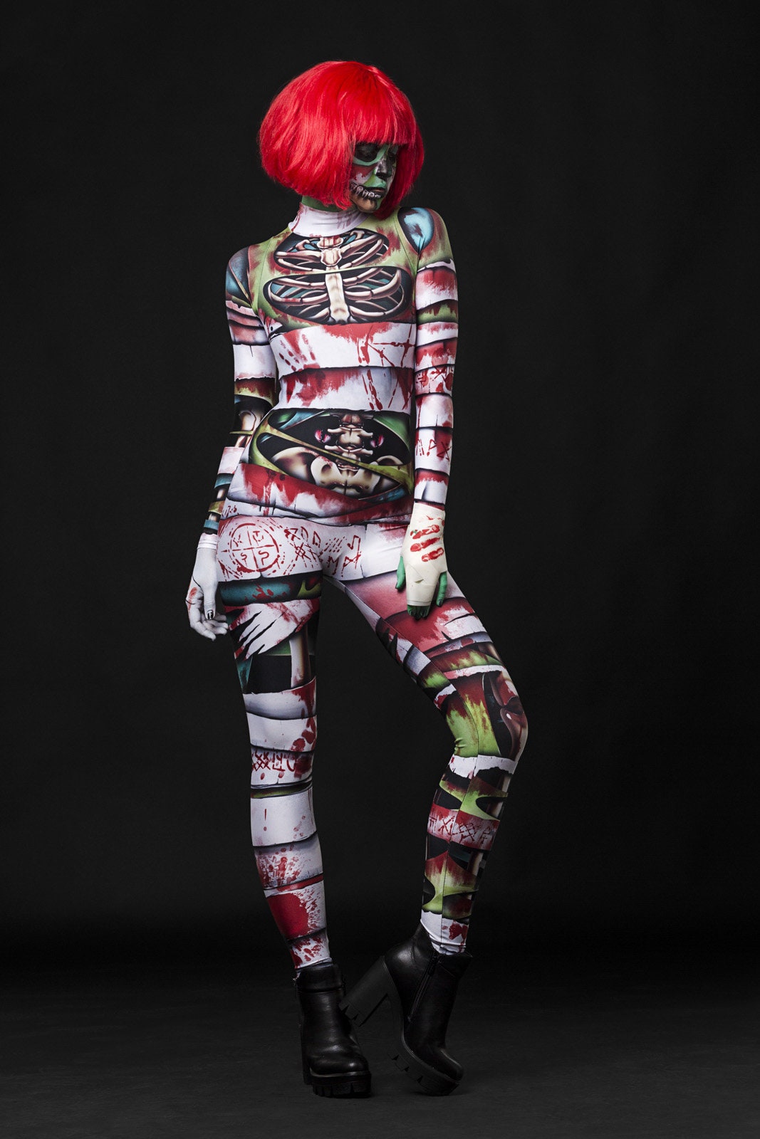 Woman posing in the Occult Mummy costume, highlighting the eerie skeleton and mummy wrap design, great for Halloween or as a standout horror festival outfit.