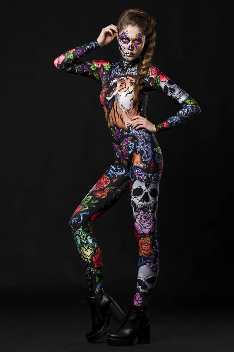 Woman posing in the Tattoo Style Halloween catsuit, showcasing the detailed tattoo-style tiger, skull, and butterfly designs, great for Halloween or as a standout festival outfit.