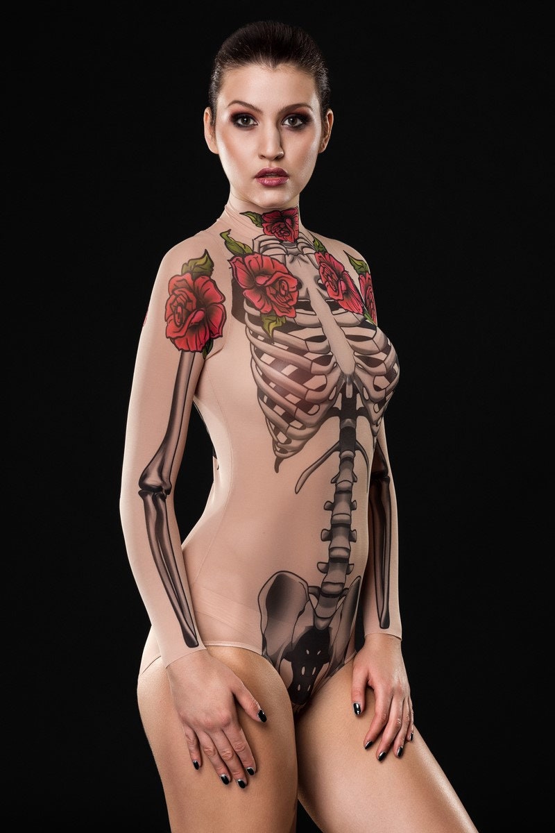 Woman wearing the Tattoo Skeleton bodysuit, featuring a detailed skeleton and tattoo design, perfect for Halloween parties or gothic-themed festivals.