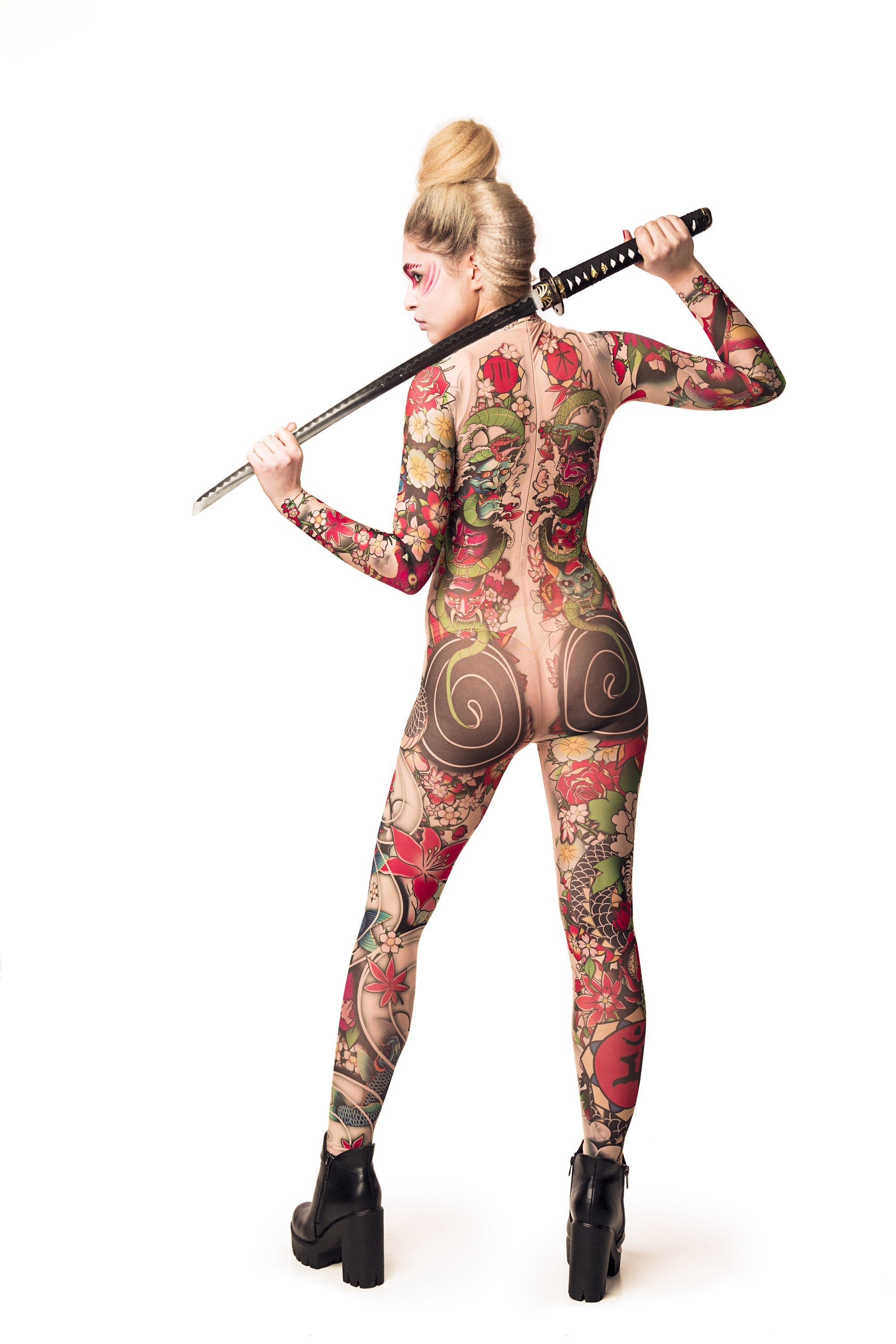 Close-up of the Japanese tattoo-style design on the Yakuza-style mesh catsuit, with the model holding a sword, ideal for a bold Halloween or festival look.