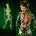 Woman wearing the Green Snake costume, a full-body snake skin jumpsuit with tattoo details on the back, perfect for Halloween or stylish festival attire.