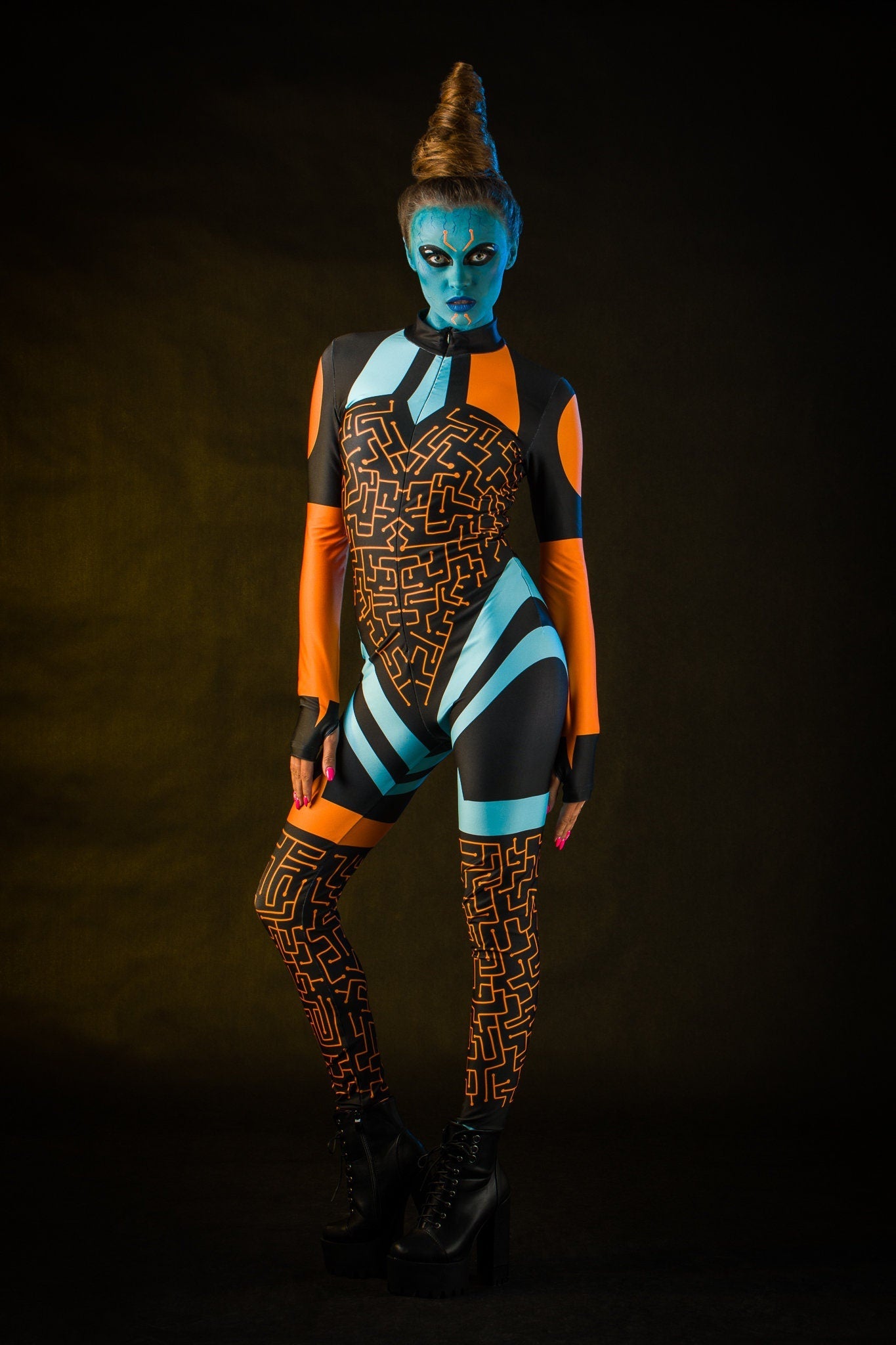 Woman wearing the Blue Alien Halloween costume, a full-body UFO-themed jumpsuit with tattoo details on the back, perfect for Halloween parties or alien-themed cosplay.