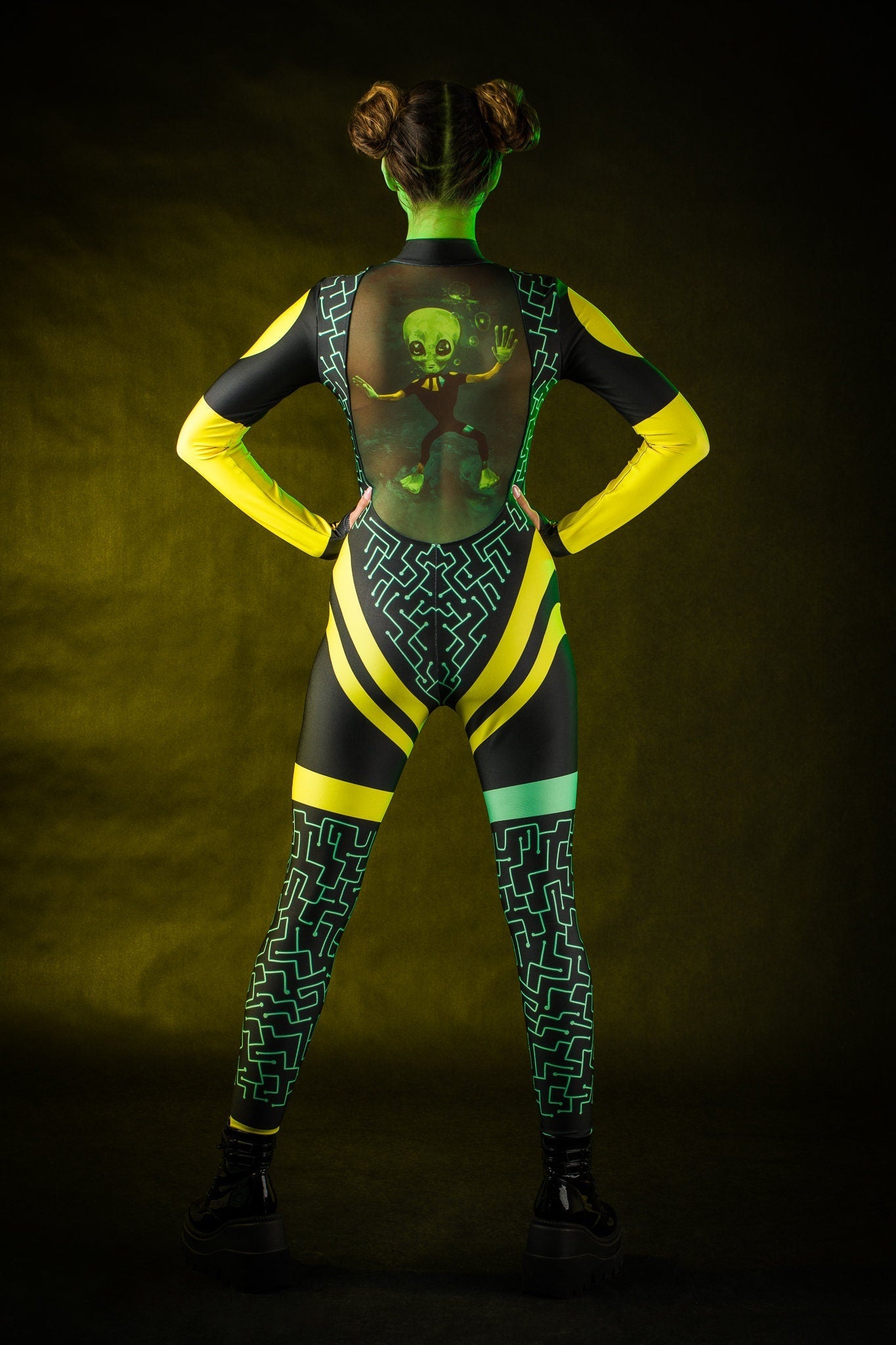 Close-up of the green alien design and tattoo effect on the back of the jumpsuit, ideal for a bold Halloween or UFO-themed festival look.