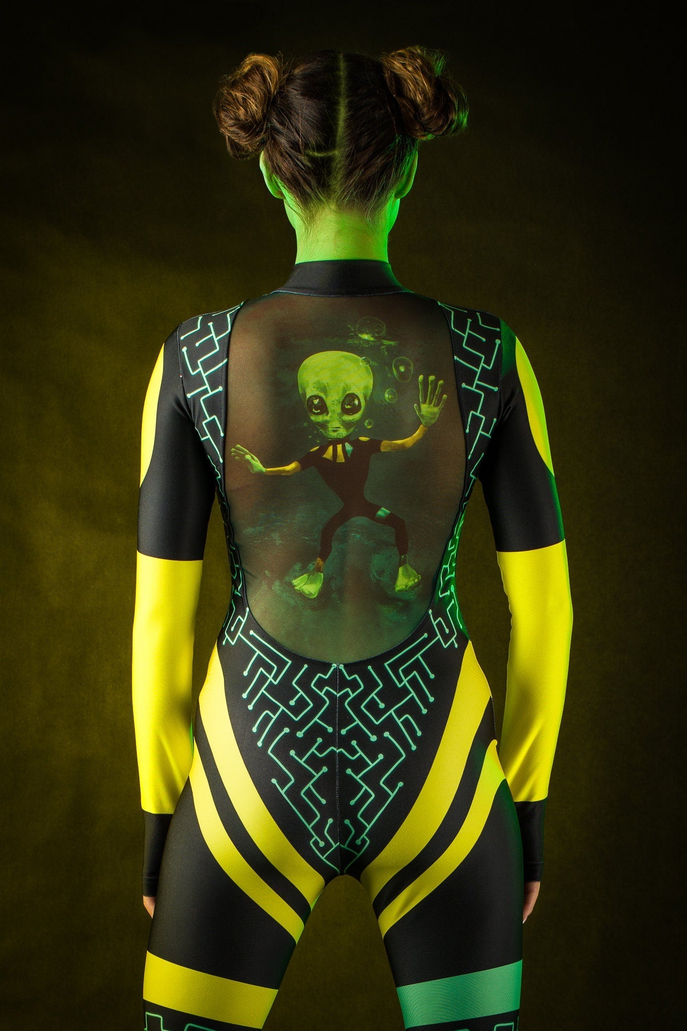 Close-up of the green alien design and tattoo effect on the back of the jumpsuit, ideal for a bold Halloween or UFO-themed festival look.