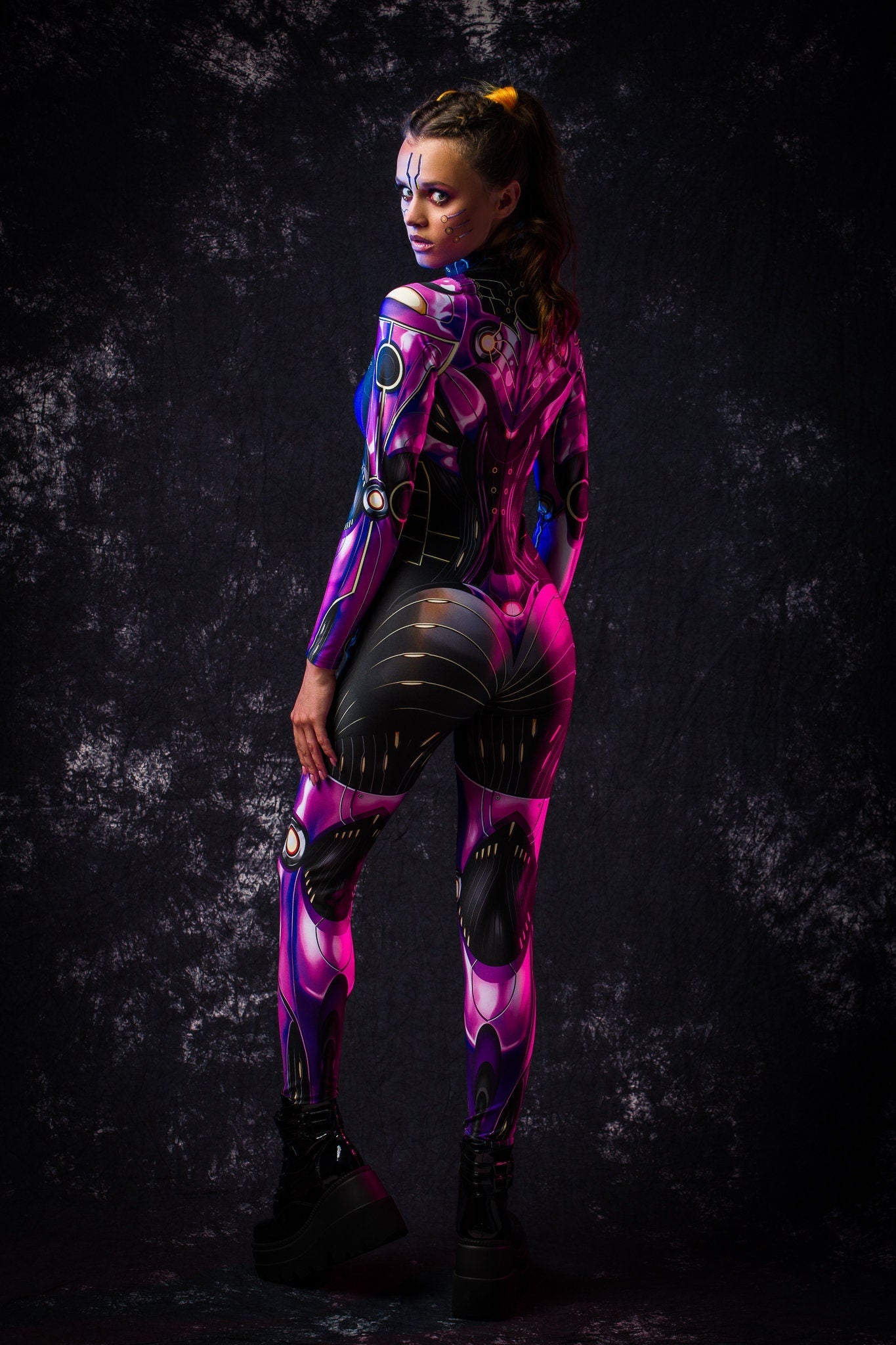 Woman posing in the Violet Android Halloween costume, highlighting the sleek robotic design and violet cyberpunk accents, great for Halloween, cosplay, or as a standout festival outfit.