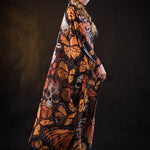 Woman wearing the Lady Orange Butterfly skeleton costume, featuring a colorful kimono with vibrant orange butterfly accents, perfect for Halloween parties or Day of the Dead events.