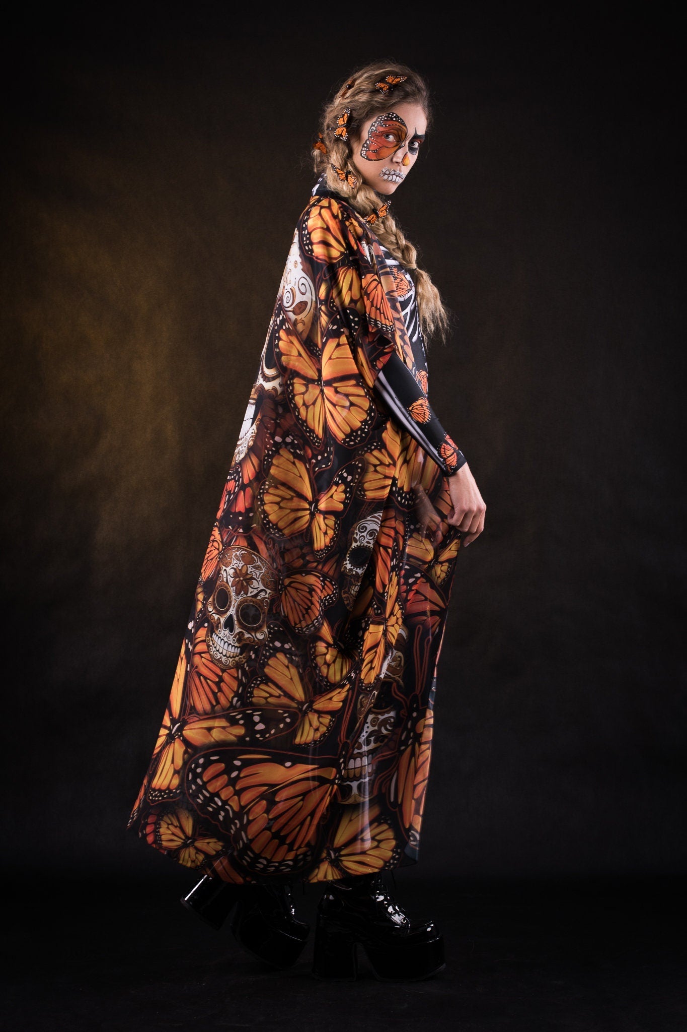 Woman wearing the Lady Orange Butterfly skeleton costume, featuring a colorful kimono with vibrant orange butterfly accents, perfect for Halloween parties or Day of the Dead events.