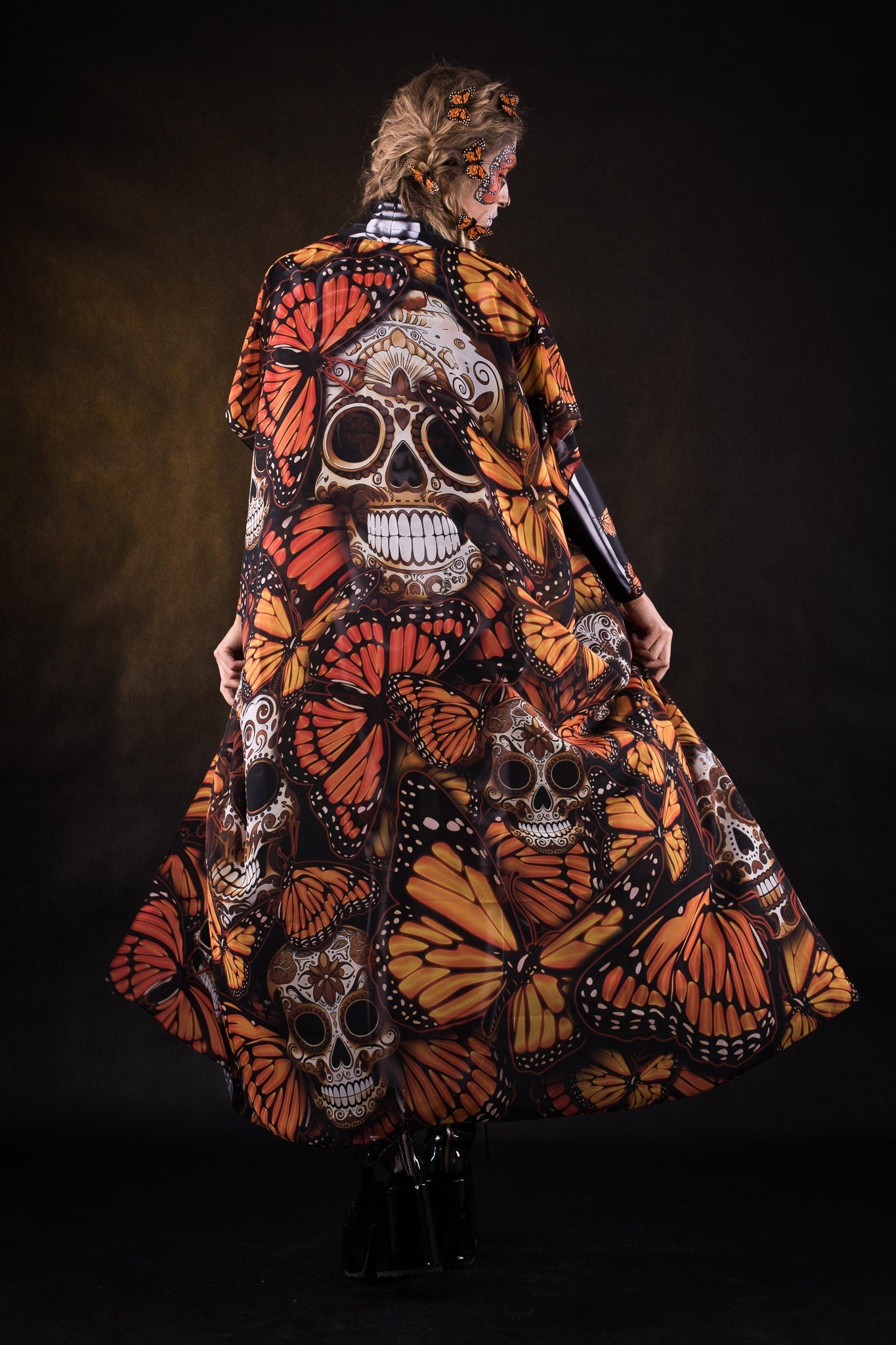 Woman posing in the Lady Orange Butterfly skeleton costume, showcasing the bold orange butterfly design, skeleton theme, and flowing kimono, great for Halloween or as a standout festival outfit.