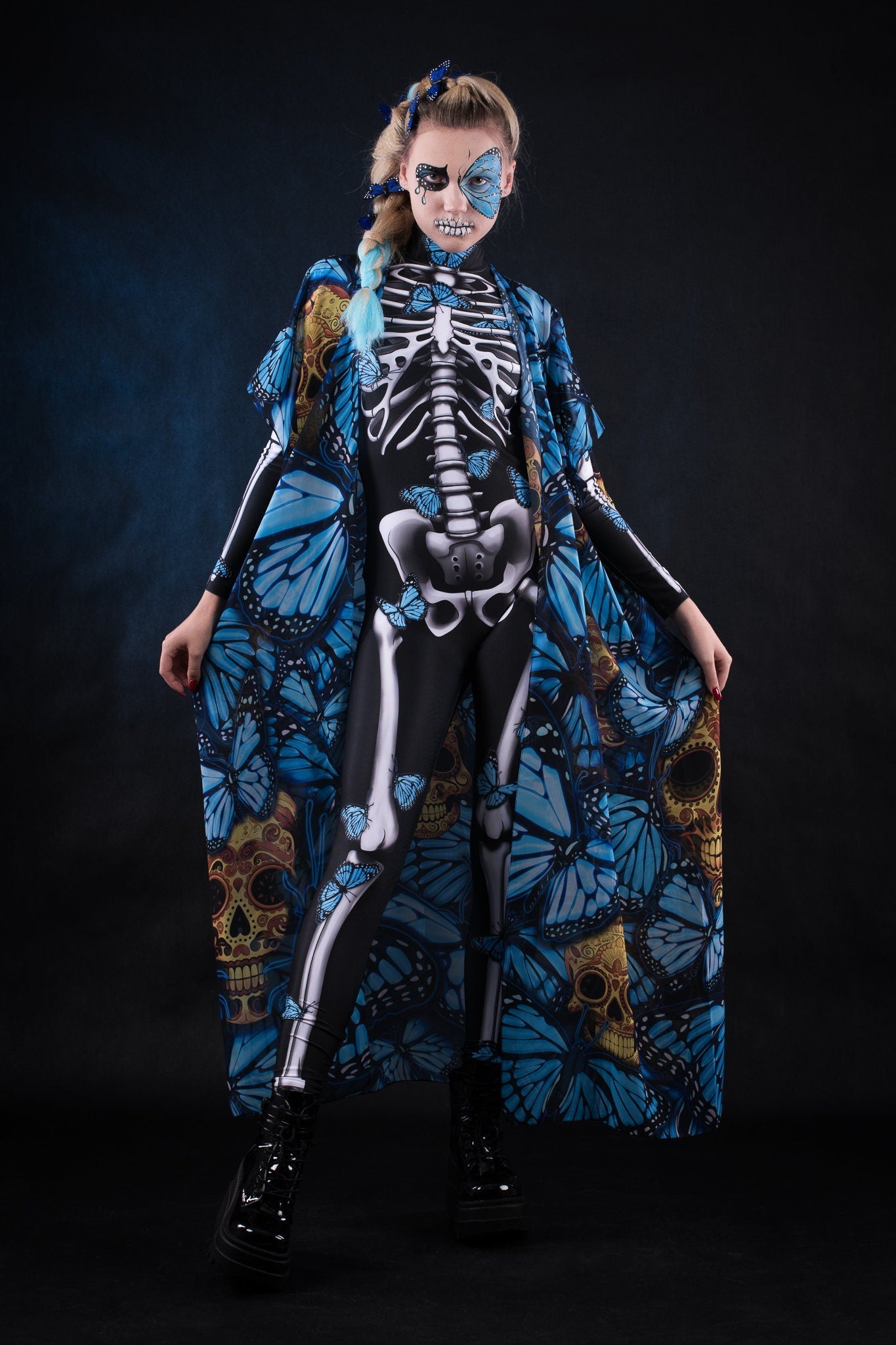 Woman wearing the Lady Blue Butterfly skeleton costume, featuring a colorful kimono with blue butterfly accents, perfect for Halloween parties or Day of the Dead events.