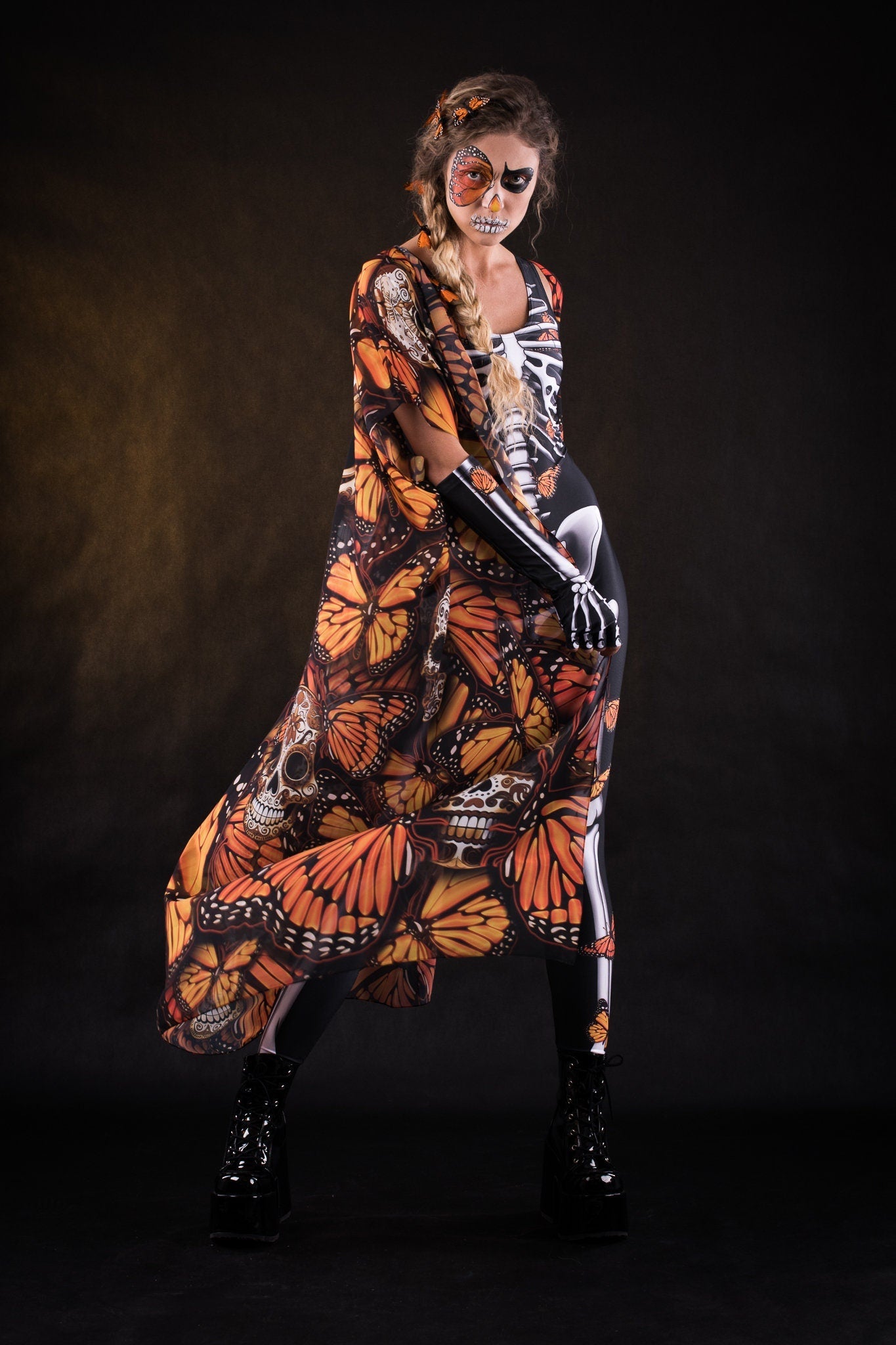 Woman wearing the Orange Butterflies Skeleton costume with kimono, featuring a white skeleton bodysuit and orange butterfly accents, perfect for Halloween or Day of the Dead celebrations.