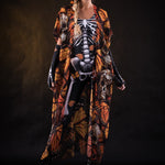 Woman posing in the Orange Butterflies Skeleton jumpsuit with kimono, highlighting the detailed butterfly and skeleton design, great for Halloween parties or as a standout festival outfit.