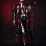 Woman wearing the Lady Death kimono Halloween cape, featuring a black cape with skull and rose accents, perfect for Halloween or Day of the Dead events.