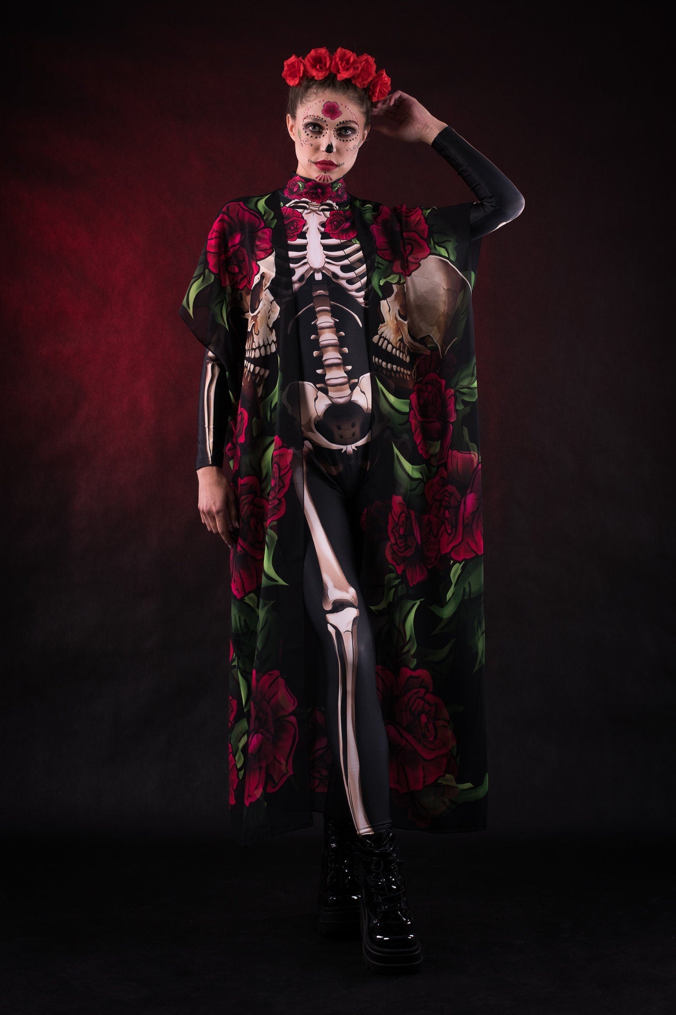 Woman wearing the Lady Death kimono Halloween cape, featuring a black cape with skull and rose accents, perfect for Halloween or Day of the Dead events.