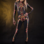 Woman posing in the Flower Skeleton costume, showcasing the colorful skeleton design with orange, yellow, and green floral patterns, great for Halloween or as a standout festival outfit.