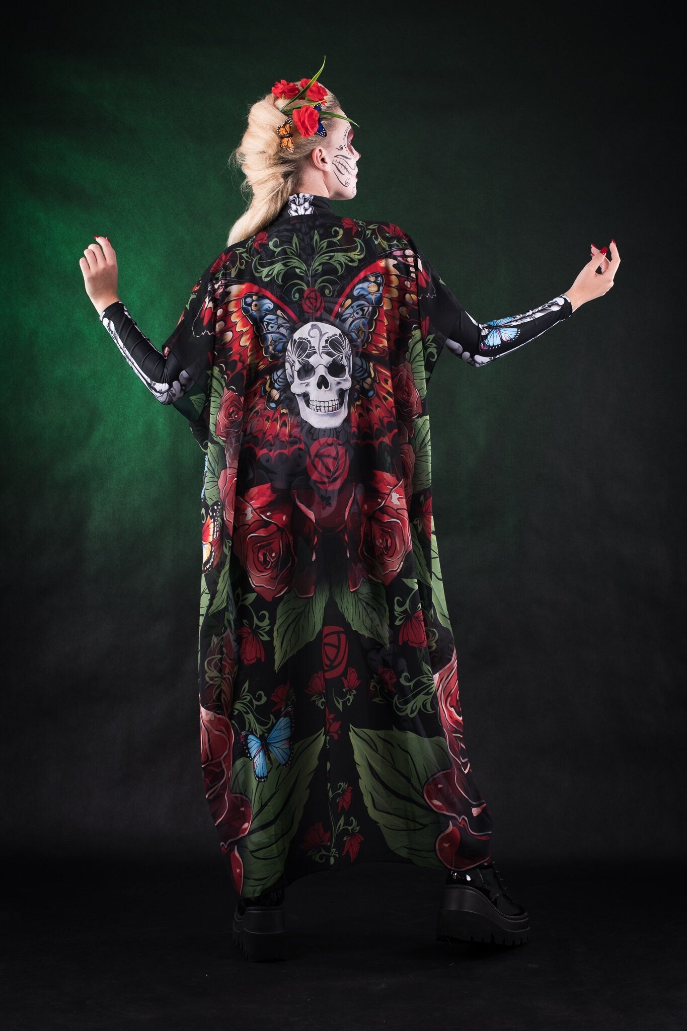 Woman wearing the Roses Butterflies Skeleton costume, featuring a full-body skeleton design with floral and butterfly accents, perfect for Halloween parties or Day of the Dead events.