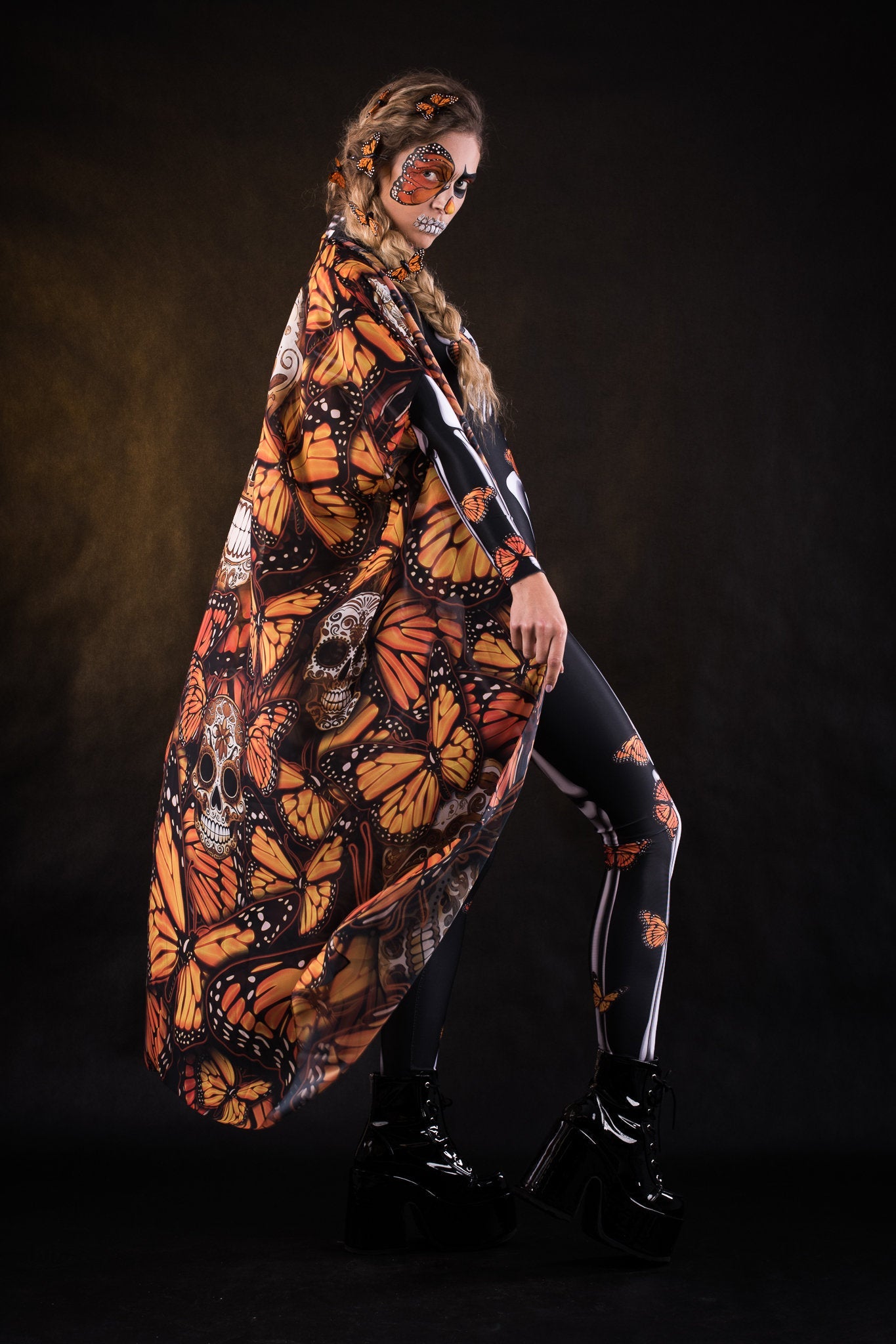 Woman posing in the Orange Monarchy Butterflies Halloween kimono cape, showcasing the bold butterfly design and elegant flow, ideal for Halloween parties or as a statement festival piece.