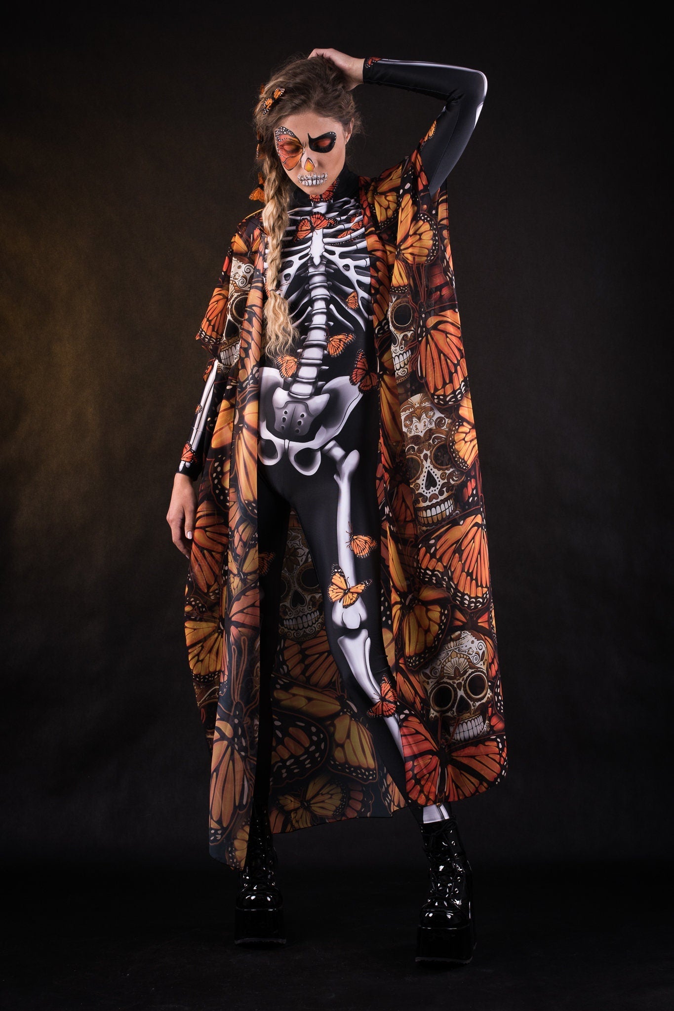 Woman wearing the Orange Monarchy Butterflies kimono cape, featuring detailed butterfly accents, perfect for Day of the Dead or Halloween events.