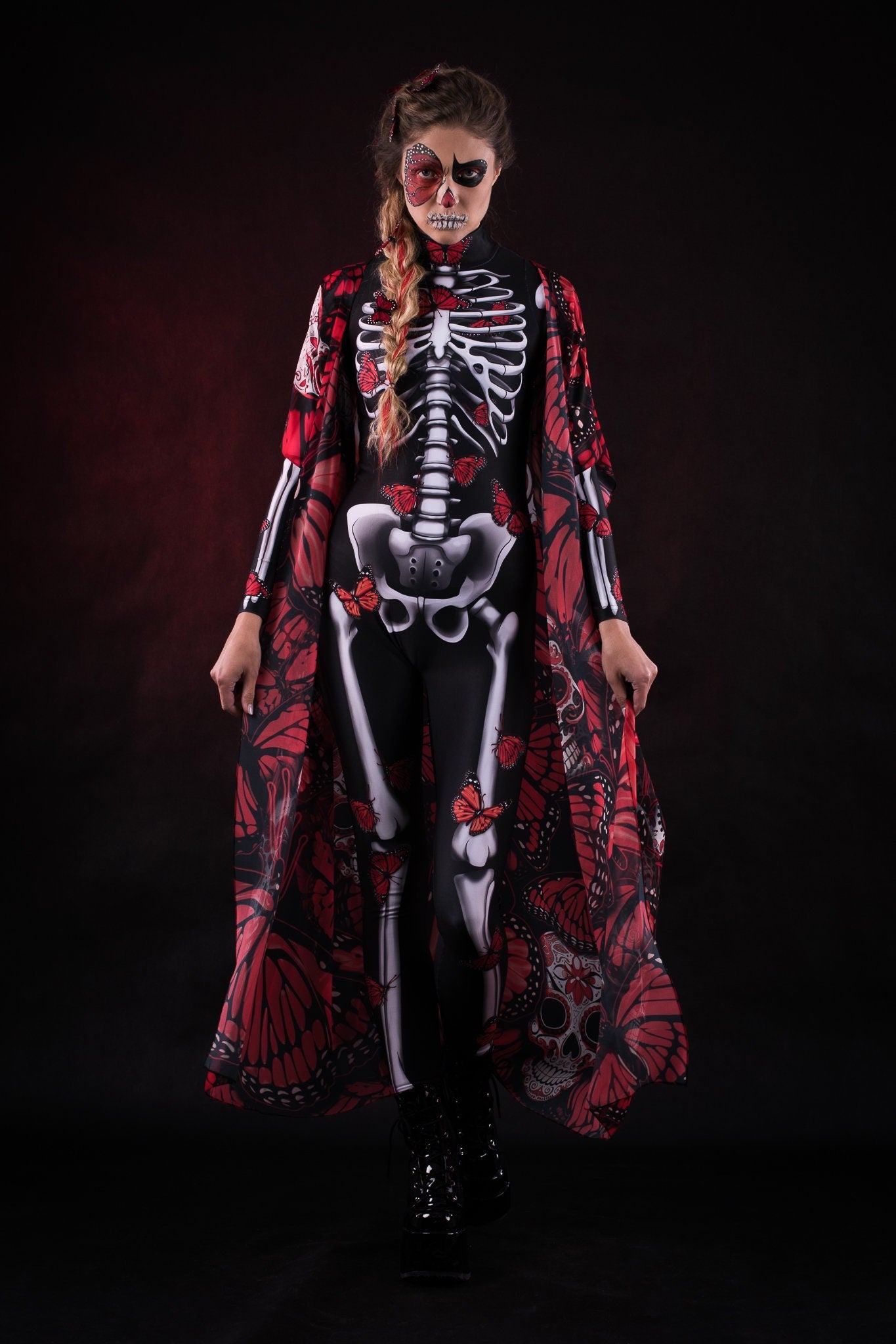 Woman wearing the Lady Red Butterfly skeleton costume, featuring a colorful kimono with red and blue butterfly accents, perfect for Halloween parties or Day of the Dead events.