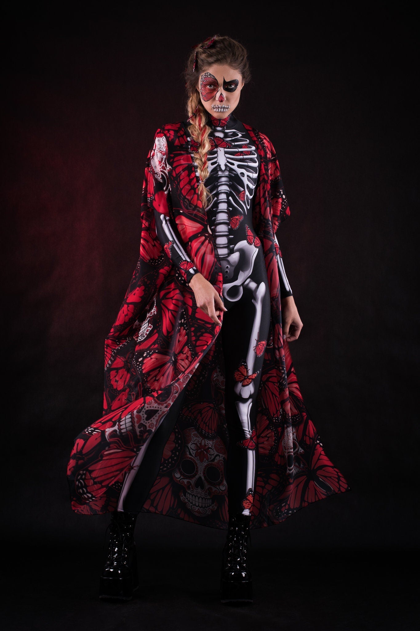 Woman wearing the Red Monarchy Butterflies kimono cape, featuring detailed butterfly accents and a flowing design, perfect for Day of the Dead or Halloween events.