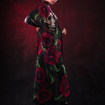 Woman wearing the Lady Death kimono Halloween cape, featuring a black cape with skull and rose accents, perfect for Halloween or Day of the Dead events.